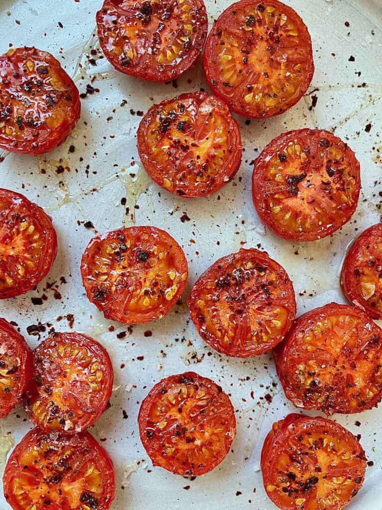 Broiled tomatoes on a platter.