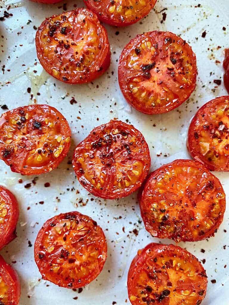 Close up picture of broiled tomatoes.